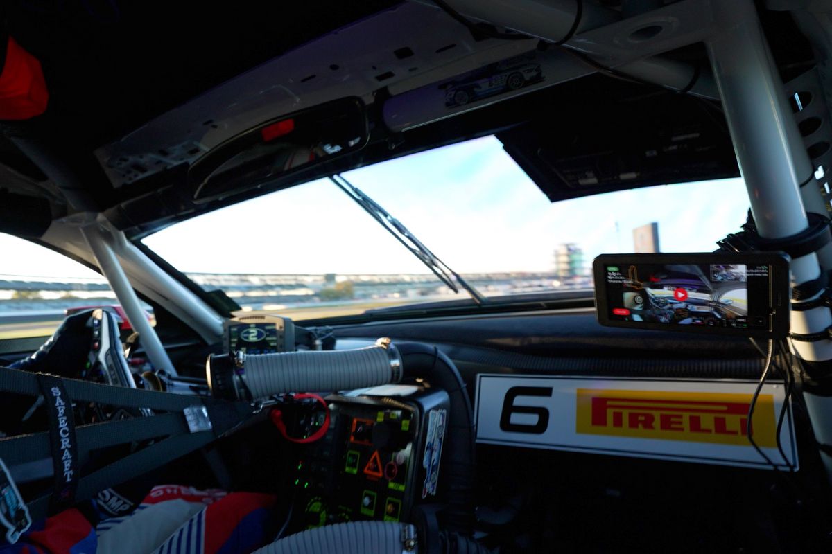 Race car interior showcasing GPX Mobile live stream kit attached to the roll bar.